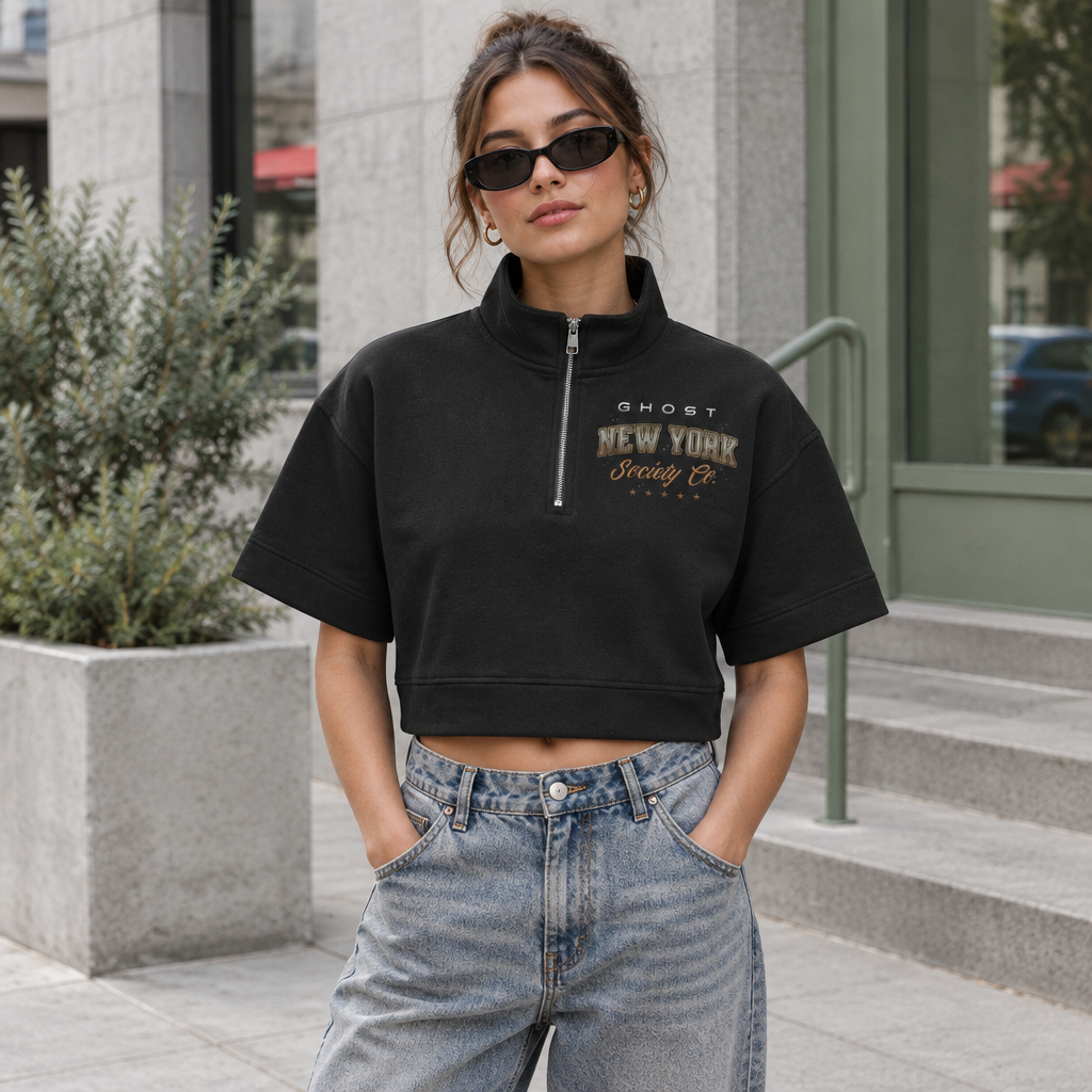Woman wearing black GHOST SOCIETY CO. quarter-zip cropped sweatshirt in a modern urban setting
